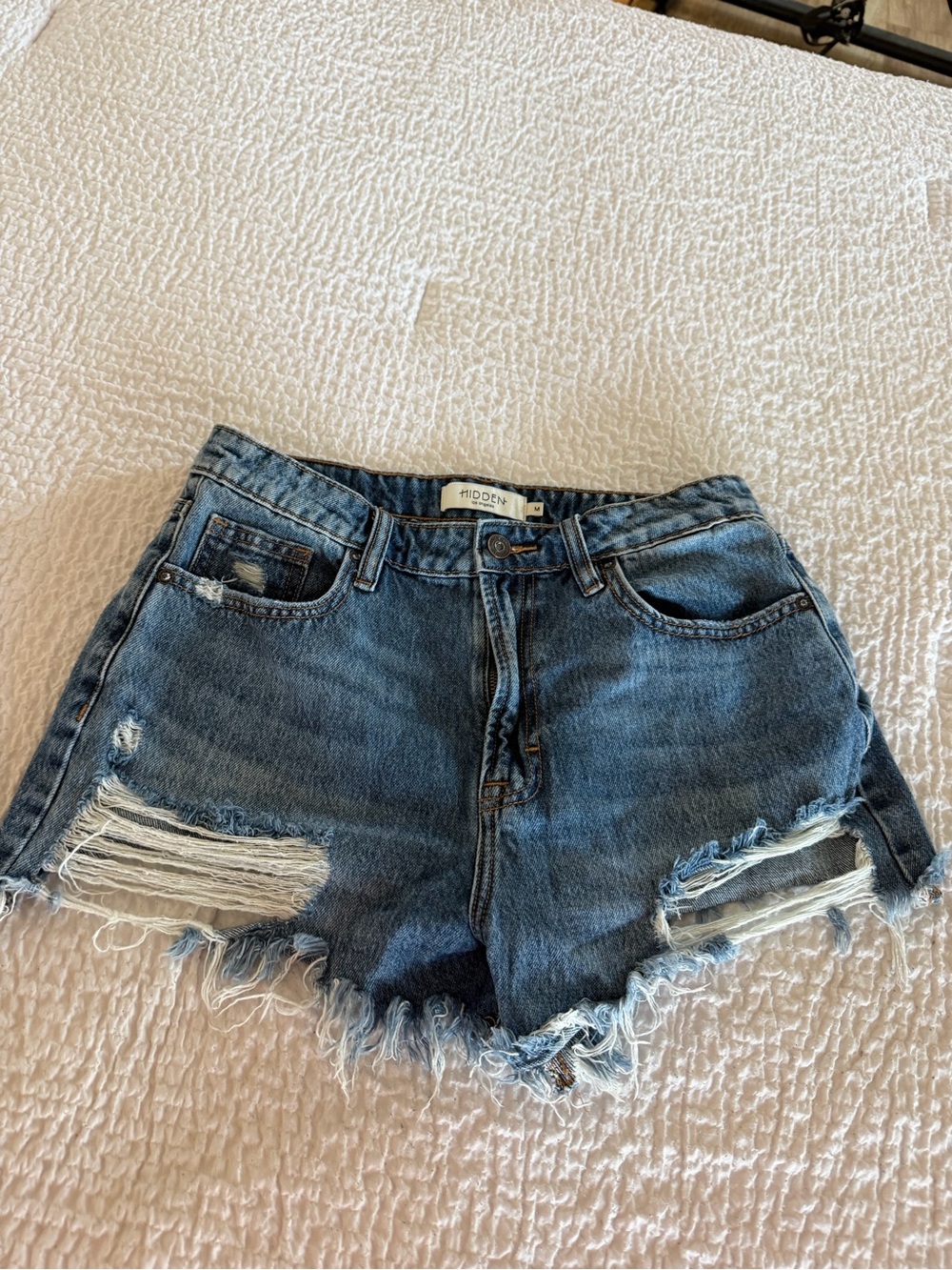 Risen High-Rise Distressed Denim Shorts in Medium Blue